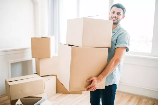 smiling-young-man-holds-cardboard-boxes-hands-housewarming-moving-new-house_266732-11006-a4b1e7c9