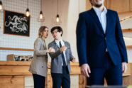 two-coworkers-staring-gossiping-about-their-male-colleague-office_1153-5434-18c2349e
