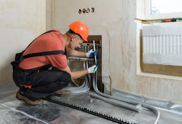 worker-installing-pipe-warm-floor-apartment_191163-1322-46201a2c